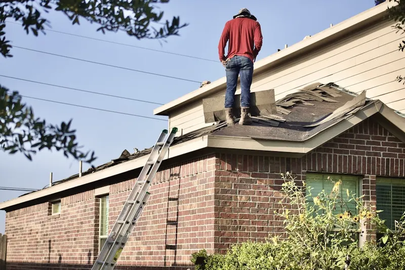 Professional roofer working on a residential roof in Upward